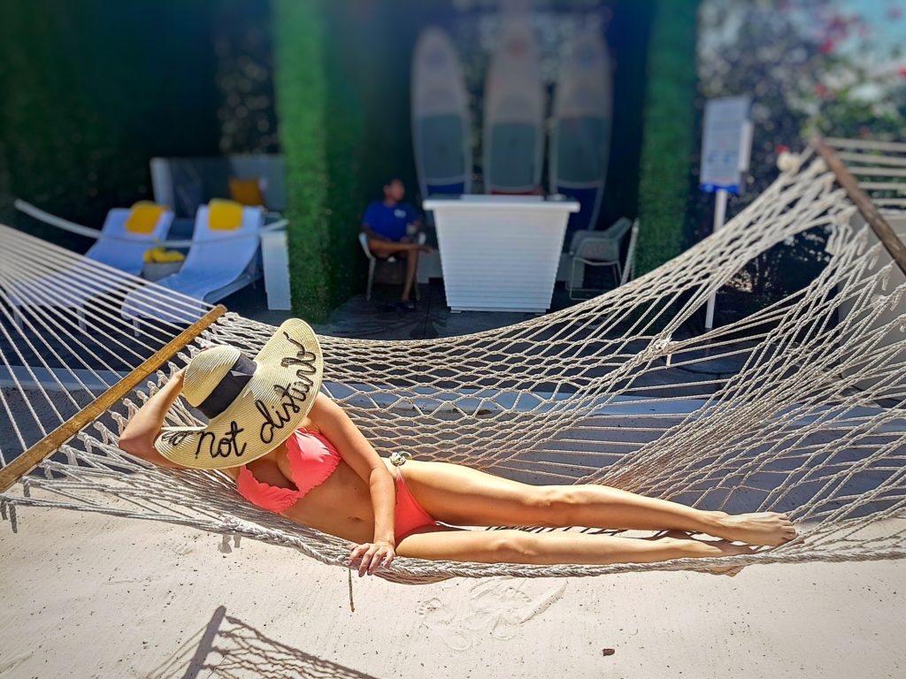 Neon bikinis with do not disturb hat on the hammock Mondrian Hotel South beach