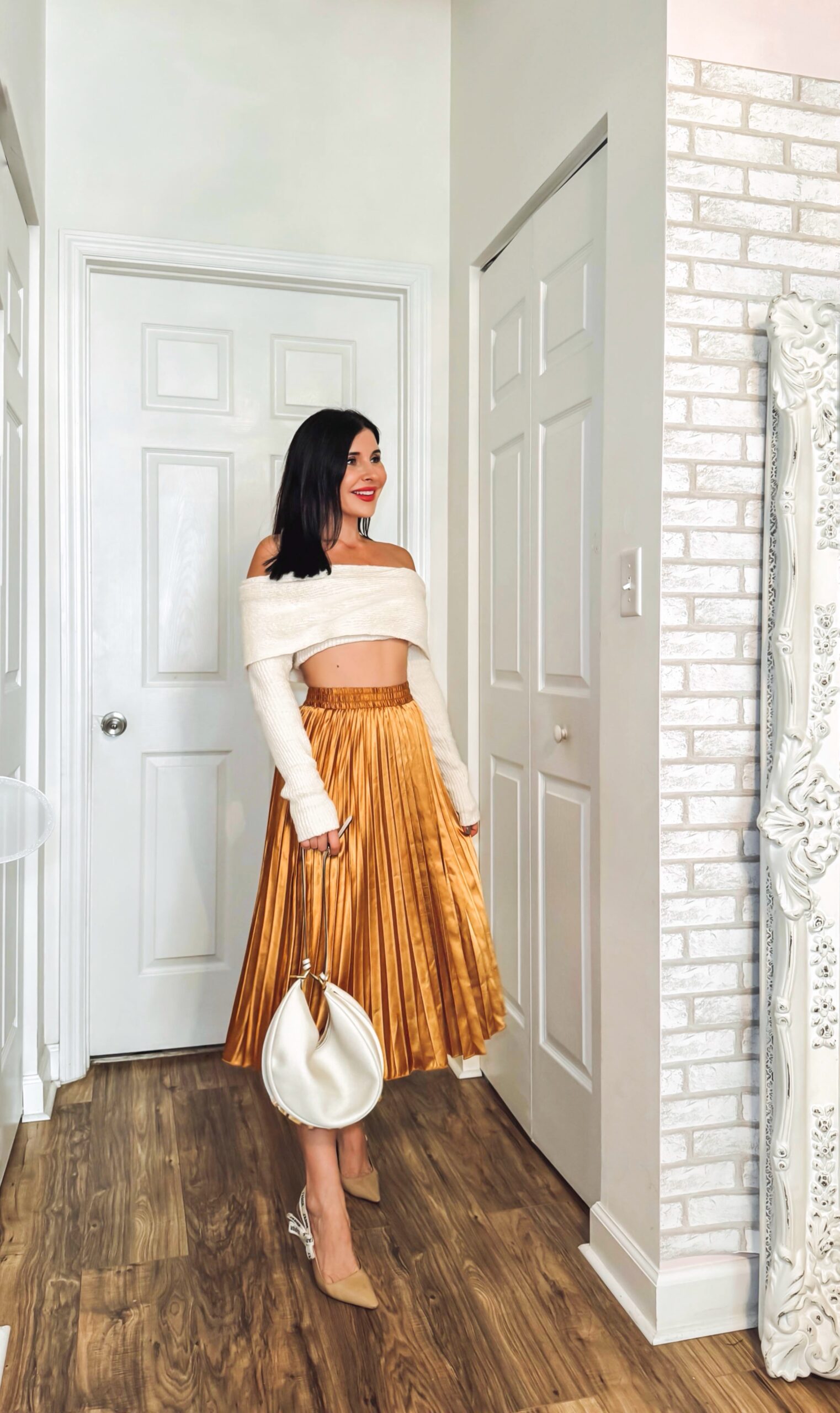 Holiday outfit inspo, gold midi pleated skirt with off shoulder crop sweater